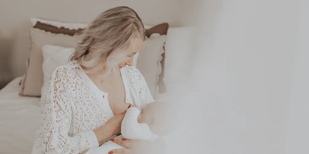 Vauva lepää äidin sylissä flunssassa – läheisyys, lepo ja imetys auttavat pientä toipumaan.